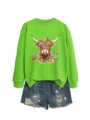 Green long sleeve sweatshirt with floral highland cow graphic paired with denim shorts. - S / Tops / Light Green