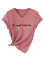 Detail view of the stylish v-neck short sleeve t-shirt with front text and knot hem. - S / Tops / Rose Gold (Black Graphic)