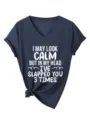 Detail view of dark blue V-neck short sleeve tee with funny slogan print and hem knot. - Navy Blue