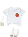 Close-up detail of cute tomato floral print kids white t-shirt paired with pearls and shoes. - 120cm / Tops / White