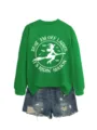 Close-up detail of the green graphic sweatshirt featuring witch print and letter details. - S / Tops / Grass Green (White Print)