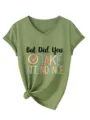 Close-up detail of the green V-neck short sleeve tee featuring graphic text chest print. - Olive Green
