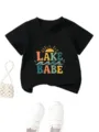 Detailed view of the black cotton children t-shirt featuring colorful lake babe graphic print. - 90cm / Tops / Black