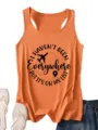 Close-up detail of the orange women's tank top featuring a travel quote graphic print. - Light Orange