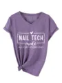 Close-up detail of purple V-neck short sleeve t-shirt with nail tech graphic print and knot. - S / Tops / Purple