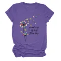 Close-up detail of the purple heather short sleeve t-shirt with book dandelion graphic. - S / Tops / Purple (Black Text)
