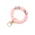 Pink silicone beaded keychain bracelet with cute daisy flower charm and gold metal hardware. - Pink