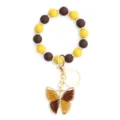 Silicone beaded bracelet keychain with charming woven butterfly pendant for women stylish. - Yellow