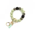 Silicone beaded keychain bracelet with leopard print beads, cute bow and tassel charms. - Bean Green