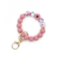 Silicone beaded wristlet keychain with floral pattern, sunflower charm and gold clasp. - Deep Pink