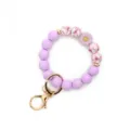 Purple silicone beaded wristlet keychain with cute daisy flower charm and gold metal clasp. - Light Purple