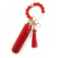 Silicone beaded wristlet keychain with red leather lipstick pouch and tassel charm. - Red