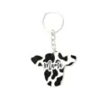 Houten koe sleutelhanger met zwart-witte koeienprint en Mama tekst voor westerse tas. - MAMA Koeienkop