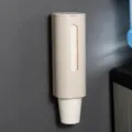 Beige wall-mounted disposable paper cup dispenser holder for home and commercial use. - Single Tube Cup Dispenser / Beige