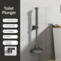 Grey plastic toilet plunger with wall-mounted holder, durable bathroom cleaning tool. - Unblocker / Gray