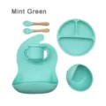 Mint green silicone baby feeding set with divided plate, bowl, cup, bib, spoon, and fork. - Mint Green