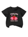Detailed view of kids black t-shirt featuring cute strawberry and flower graphic print design. - 90cm / Tops / Black
