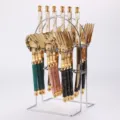 Stainless steel cutlery set with marble pattern handles, golden titanium finish and storage rack. - 24-Piece Set (PVC Box with Stand) / PVC Box / Titanium Plated