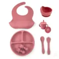 Silicone baby feeding set detail showing divided plate, bowl, bib, cup, and spoons. - 8-Piece Set / Brick Red