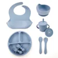 Silicone baby feeding set detail showing suction bowl, bib, plate, cup and spoon. - 8-Piece Set / Grey Blue