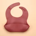 Burgundy silicone baby bib with crumb catcher pocket and adjustable buttons for toddlers - Brick Red