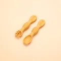 Silicone baby training spoon set in yellow, food-grade material with textured handle. - Turmeric