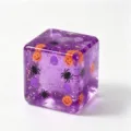 Close-up detail of Halloween purple cube squishy toy with glowing pumpkin and spider inside. - Purple