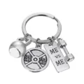 Fitness gym metal keychain detail view showing barbell and kettlebell charms clearly - Fitness Equipment Style