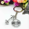 Metal gym fitness keychain with dumbbell and barbell plate charms, creative keyring accessory. - Fitness & Eiffel Tower Style