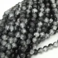 Detailed view of black crackle glass beads, perfect for DIY jewelry making and apparel accessories. - 8mm / Black and White
