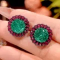 Close-up detail of vintage green stone and red crystal cluster luxury jewelry design. - Black Gold Stud Earrings