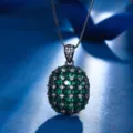 Close-up view of the elegant black gold-plated oval green gemstone pendant sparkling brilliantly. - Pendant Necklace With Chain (ZS687) / Green