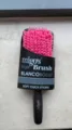 Detailed view of the quick-dry hair brush featuring soft pink bristles and black handle. - Black