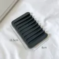 Black silicone soap dish holder with drainage slots for the bathroom countertop. - Solid Black