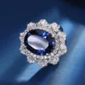 Luxury oval blue sapphire cluster ring featuring dazzling crystal pavé for classic elegance. - Ring / Blue