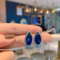 Exquisite pear-shaped blue glass rhinestone drop earrings detail view, elegant fashion jewelry. - Blue Glass Stud Earrings