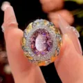 Close-up detail of vintage style woven ring with oval pink center stone and sparkling halo. - Dry Rose Ring