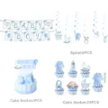 Detail view of blue baby boy party decorations set including banner, cake toppers and swirls. - Four-Piece Set