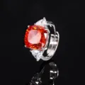 Silver-tone ring with vibrant orange cushion main stone and pear side stones. - Ring / Orange Red Nest Cut