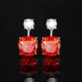 Close-up of elegant drop earrings featuring sparkling white and vibrant orange cushion-cut stones. - Stud Earrings / Orange Red Nest Cut