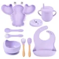 Purple silicone baby tableware set including suction plate, bowl, cup, spoon, fork, and bib. - Set / Lavender