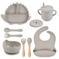 Set de vajilla de silicona para bebé con plato dinosaurio, bol, vaso, cuchara, tenedor y babero. - Conjuntos / Gris
