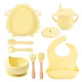 Baby silicone tableware set with suction plate, training cup, bowl, spoon, fork, and bib in soft yellow. - Y11 Lamb Set