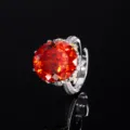 Closeup of luxury orange oval gemstone ring with sparkling pave diamonds and adjustable band. - Adjustable Open / Cushion Cut Orange Red Ring