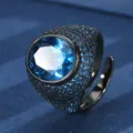 Detailed view of black gold plated oval blue gemstone statement ring with pavé small stones. - Oval Main Stone (ZS1149 Black Gold) / Black Gold Blue Synthetic Spinel Ring