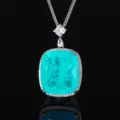 Detailed close-up of a large cushion-cut blue gemstone pendant necklace with dazzling stones. - Pendant With Chain / Paraiba Blue