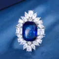 Dettaglio in primo piano del lussuoso anello con grande gemma blu e zirconi scintillanti. - Anello / Blu Zaffiro