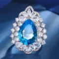Stunning pear-shaped blue gemstone ring detail with sparkling white zircon halo for women. - Ring Only (Blue)