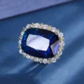 Luxury cushion cut deep blue gemstone detail ring with sparkling crystal halo frame. - Ring / Sapphire Blue