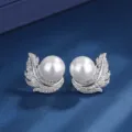 Detailed shot of exquisite silver pearl leaf earrings with sparkling cubic zirconia stones. - Earrings Only